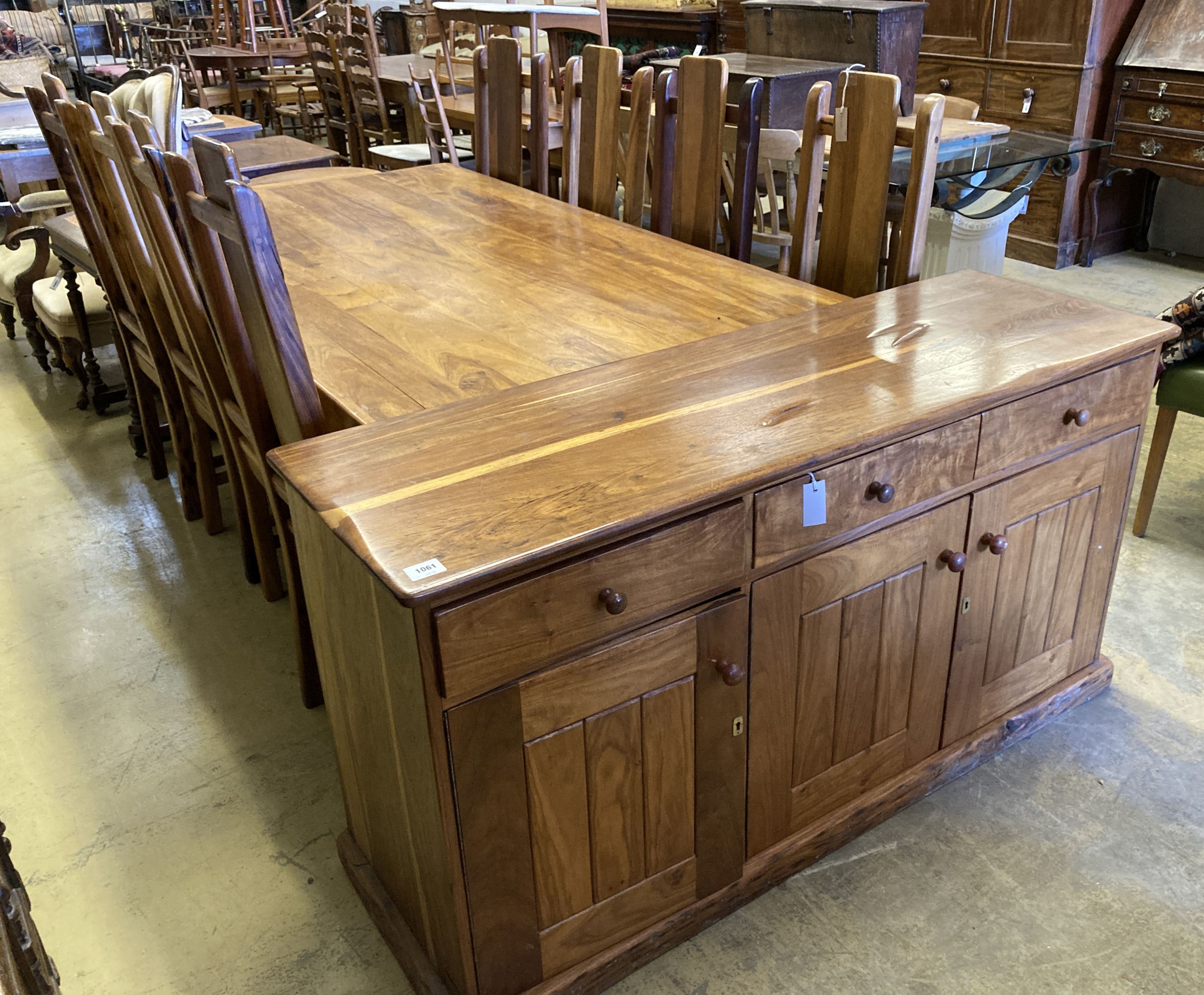 A contemporary colonial style dining suite, comprising rectangular table length 200cm, depth 118cm, height 78cm, eight chairs and a sid